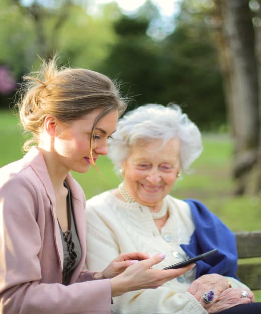 An old lady and woman looking at a mobile phone